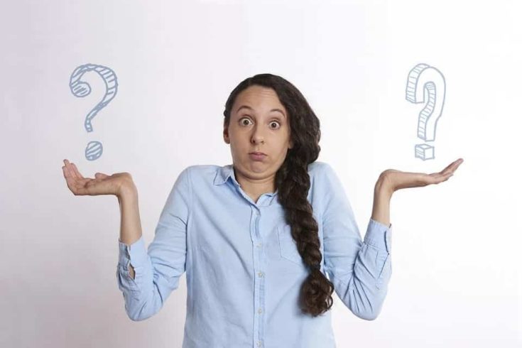 woman thinking, raising her both hands with question mark
