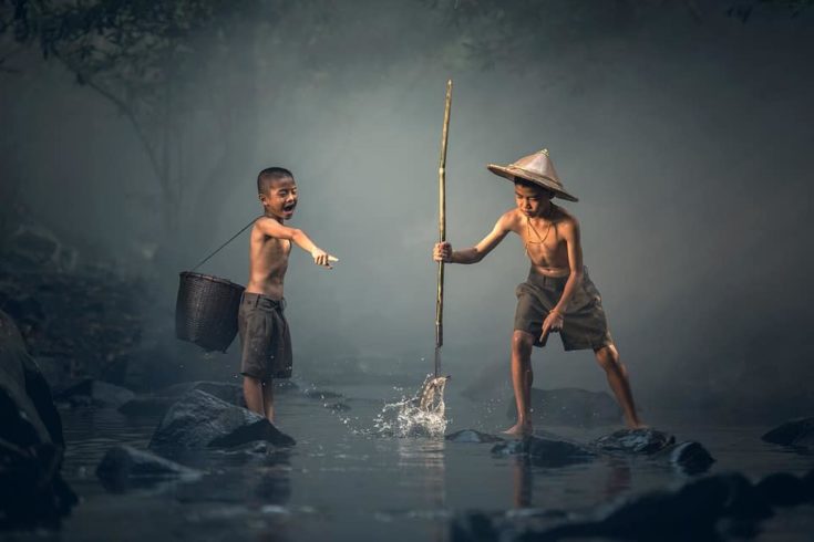 children fishing on the river