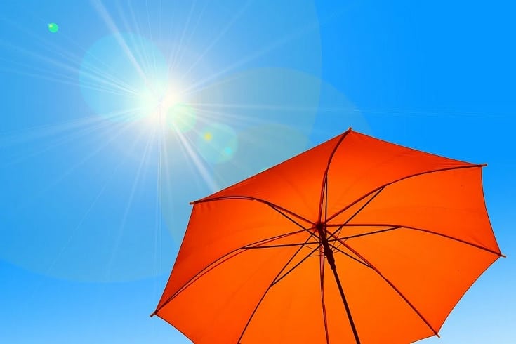 bright sun in the sky and orange umbrella