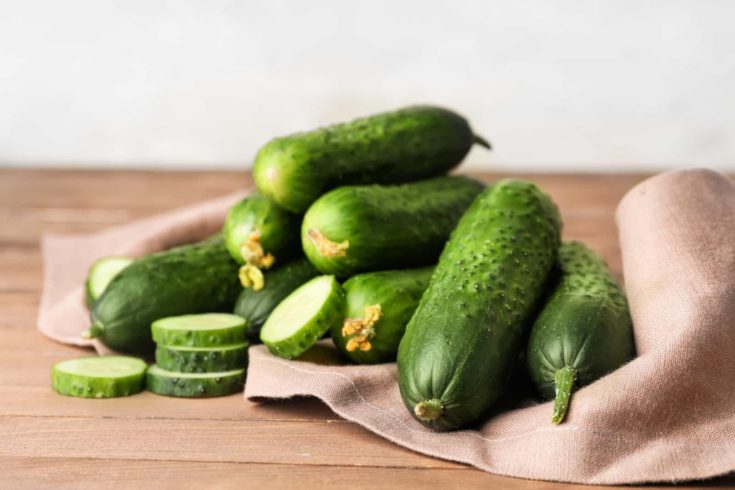 Green cucumbers on wooden table